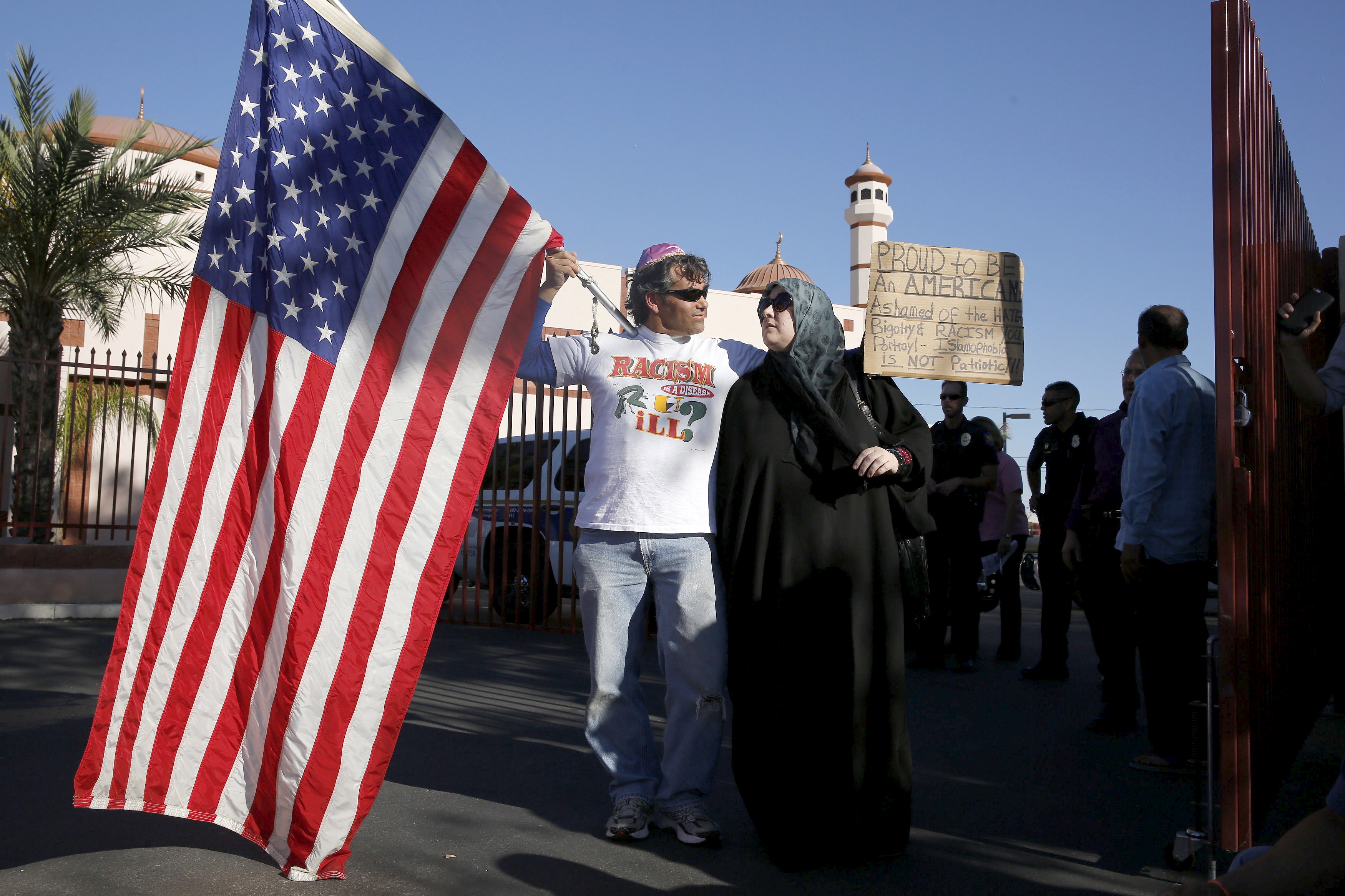 Two demonstrators stand in front of the Islamic Community Center to oppose the "Freedom of Speech Rally Round II" across the street in Phoenix, Arizona May 29, 2015. Photo by Nancy Wiechec/Reuters.