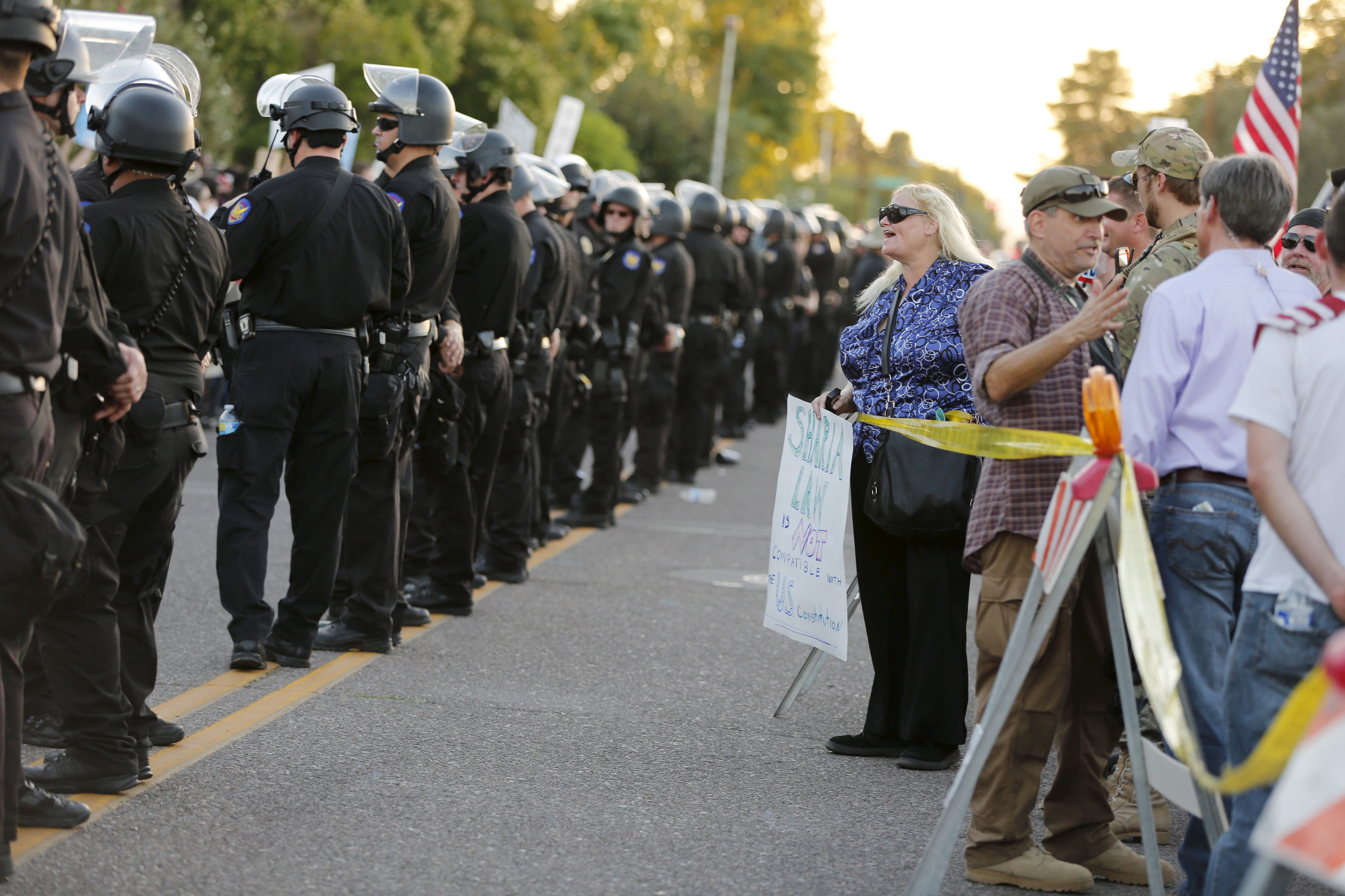 A police line separates people attending the "Freedom of Speech Rally Round II" from counter demonstrators outside the Islamic Community Center of Phoenix. Police were on high alert because of a shooting at an anti-Muslim event in Texas in early May. Photo by Nancy Wiechec/Reuters.