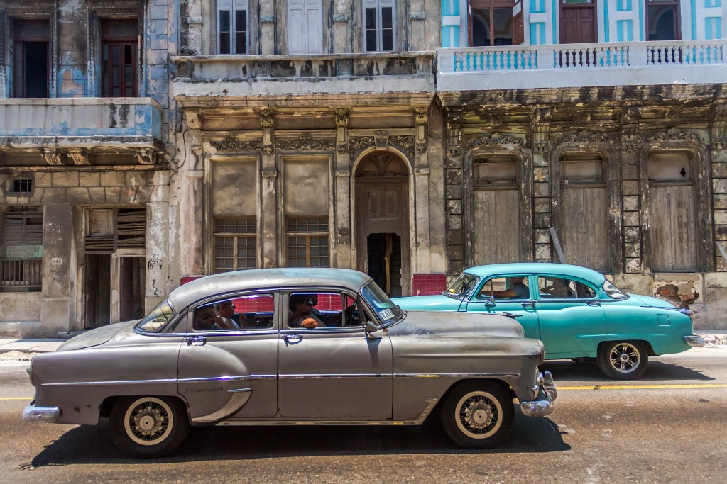 Old cars pass buildings falling apart near the Malecon in Havana. Cuba is truly a place "frozen in time." Photo by Frank Carlson