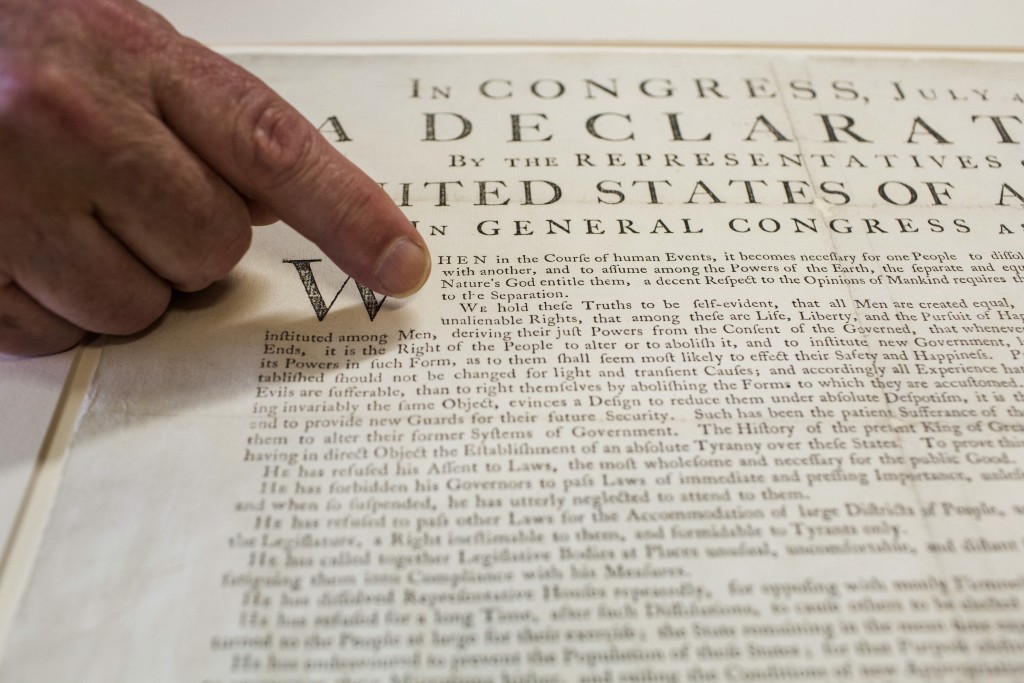 Peter Drummey, chief reference librarian of the Massachusetts Historical Society, points to a rare copy of the Declaration of Independence, known as a 'Dunlap Broadside,' at the society in Boston, Massachusetts, U.S., on June 29, 2015. Photo by Shiho Fukada/Bloomberg via Getty Images