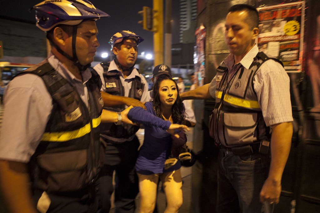 Though prostitution in Peru is not illegal, many transwomen are oftentimes taken by police on the basis of not being able to show their identification cards. Here, Kiara is taken by the municipal police officers, in a nightly raid. Photo and caption by Danielle Villasana