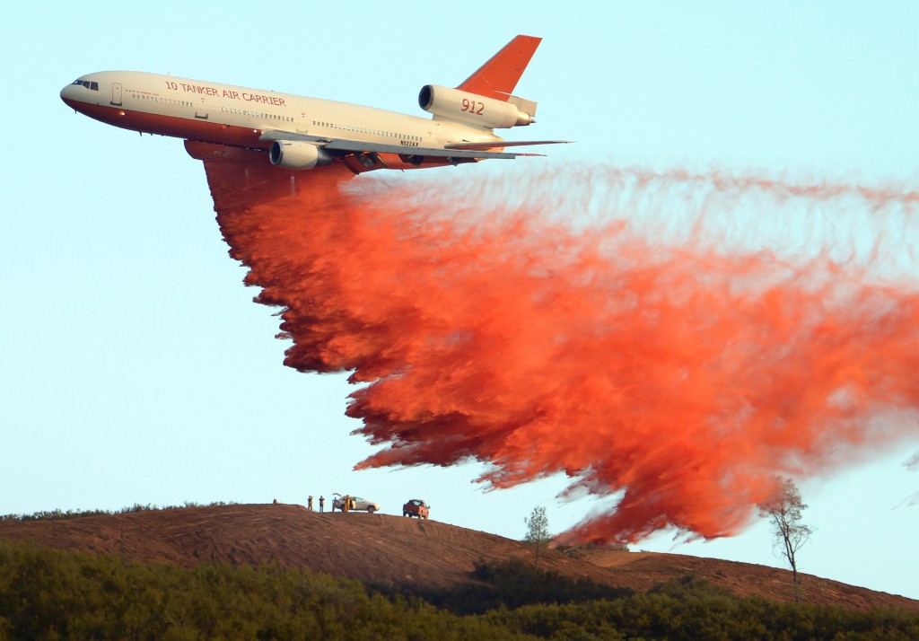 An air tanker drops fire retardant along a ridge to help contain the Rocky fire near Clearlake, California on August 2, 2015. Photo by Josh Edelson/AFP/Getty Images