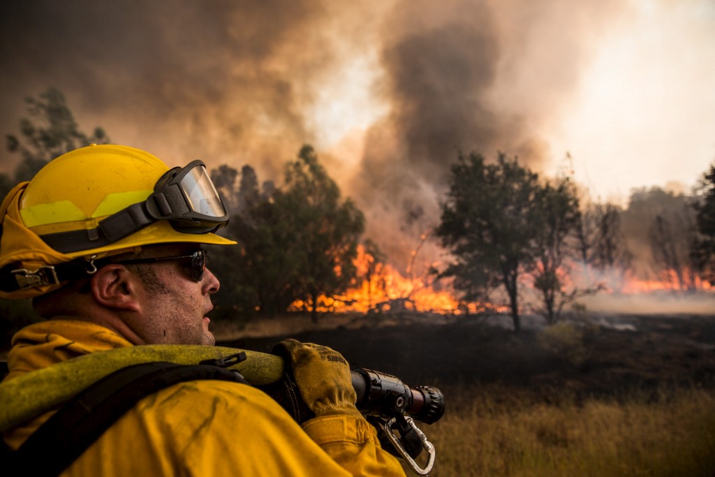 A firefighter watches for spot fires at the Rocky Fire in Lake County, California July 30, 2015. Photo by Max Whittaker/Reuters