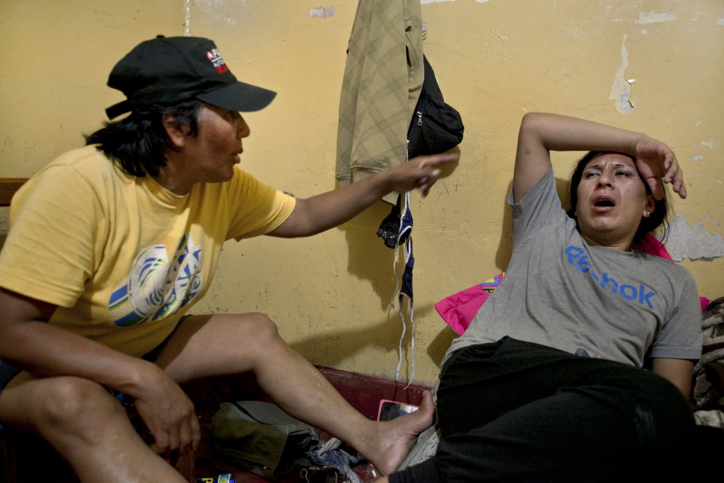 After many hours of drinking, Tamara, right, and her mother Evila, left, argue about her work on the streets.