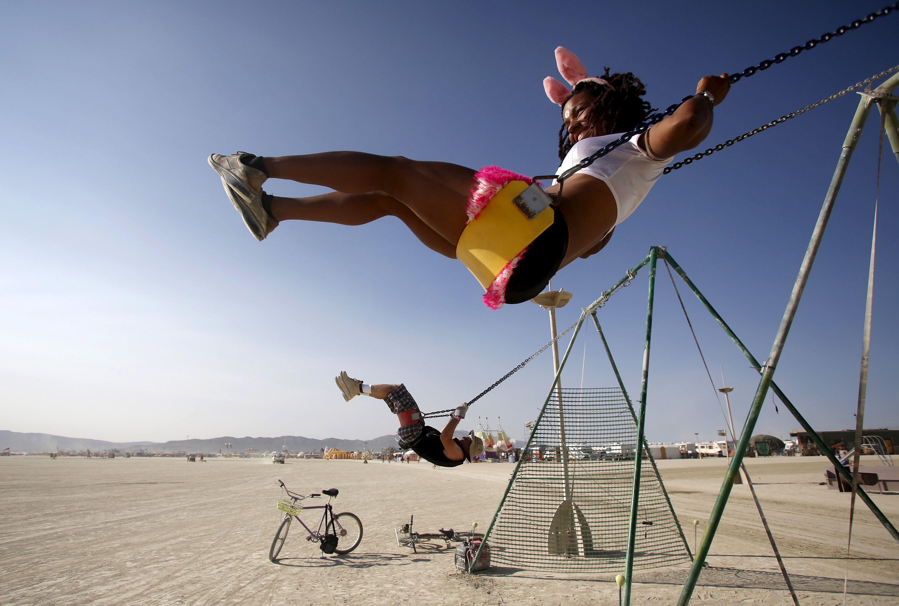 Adorable, her Playa name, swings during the carnival-like Burning Man festival. Playa, the Spanish word for beach, also describes the dry lake beds in the American west. Photo by Jim Urquhart/Reuters