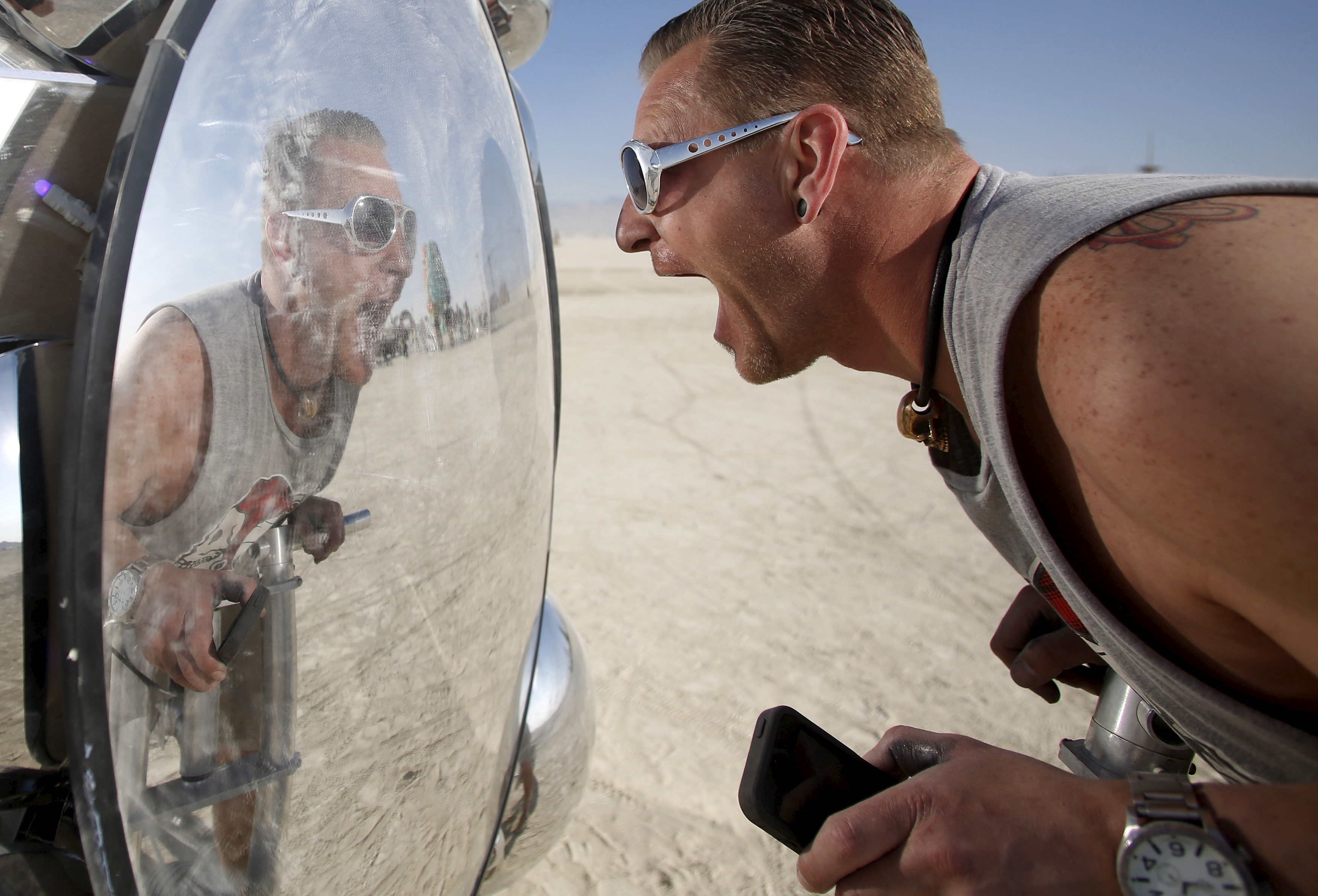 Wilf Griese interacts with the art installation Compound Eye during the desert fest on Sept. 1. Photo by Jim Urquhart/Reuters