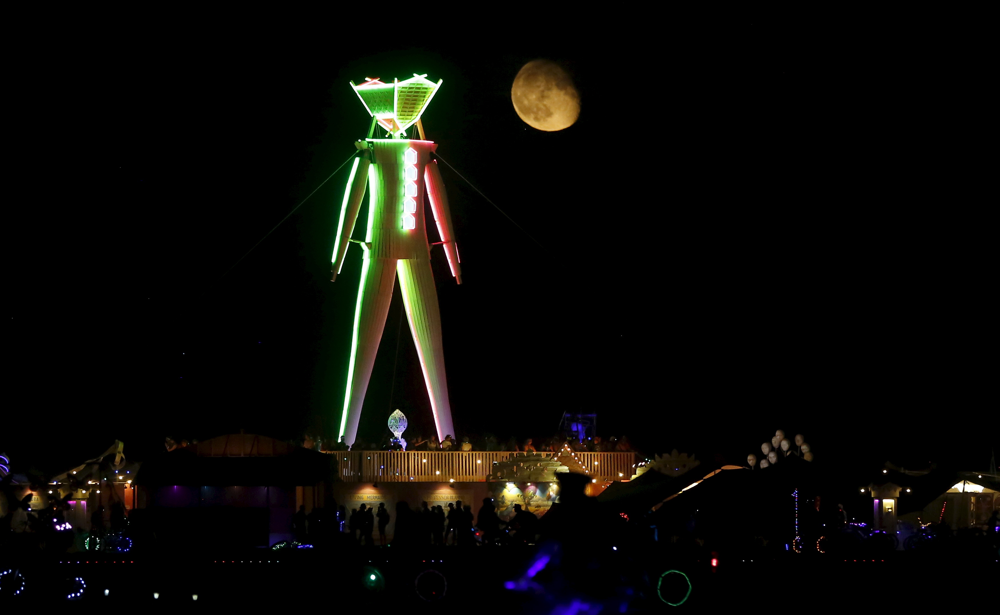 The moon rises behind the effigy that will be lit ablaze at the culmination of the Burning Man festival, which celebrates music, art and community. Photo by Jim Urquhart/Reuters