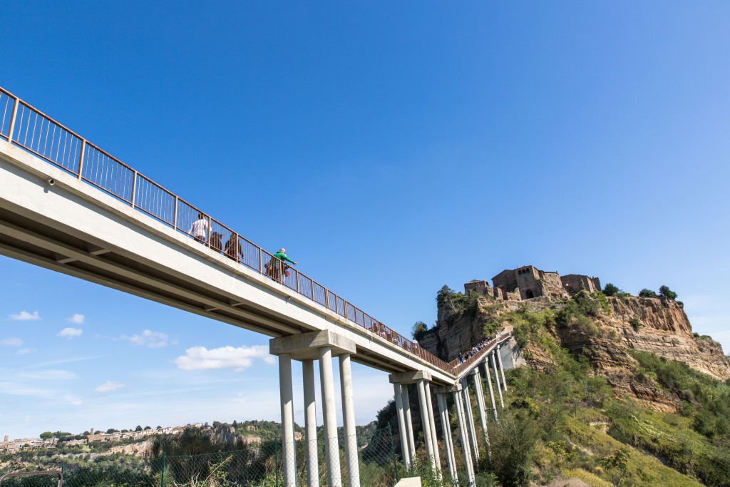 Tourists and residents access Civita di Bagnoregio by way of a steep footbridge. But earlier this year there was a collapse near its base that now needs shoring up. Photo by Frank Carlson