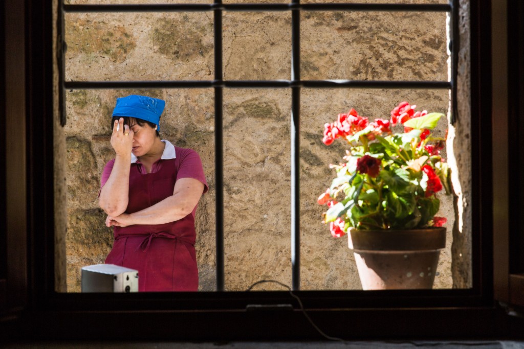 A worker takes a cigarette break outside the Alma Civita restaurant. Photo by Frank Carlson