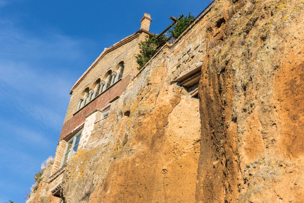 A look at the southside of Civita di Bagnoregio from the path below reveals the encroachment of landslides on the town. Photo by Frank Carlson