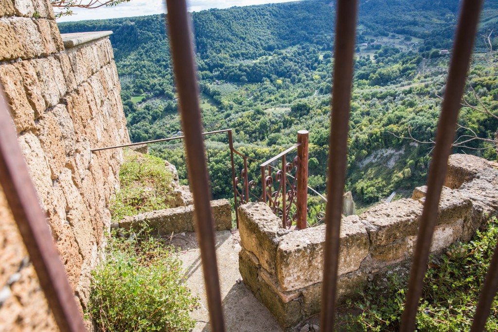 For hundreds and even thousands of years, the town of Civita di Bagnoregio has been gradually falling apart due to landslides. Here a gate prevents tourists from descending a staircase that leads off a cliff. Photo by Frank Carlson