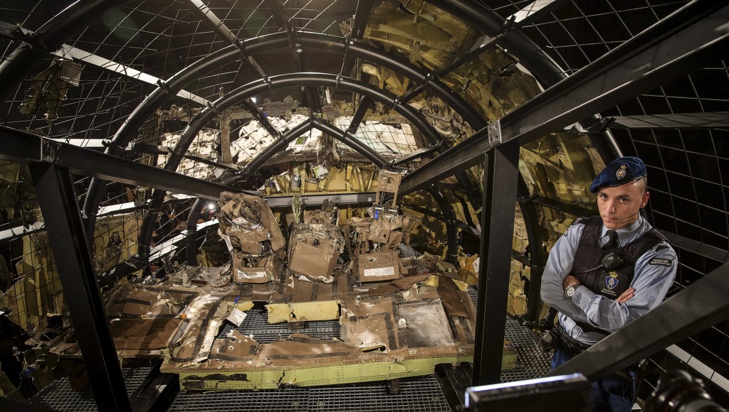 A military policeman stands guard in the cockpit of the reconstructed MH17 airplane. Photo by Michael Kooren/Reuters