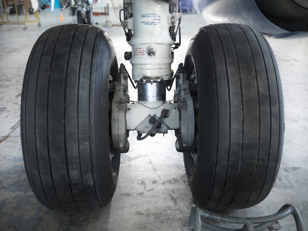 Close up of airplane wheels in hangar. Photo by Monty Rakusen