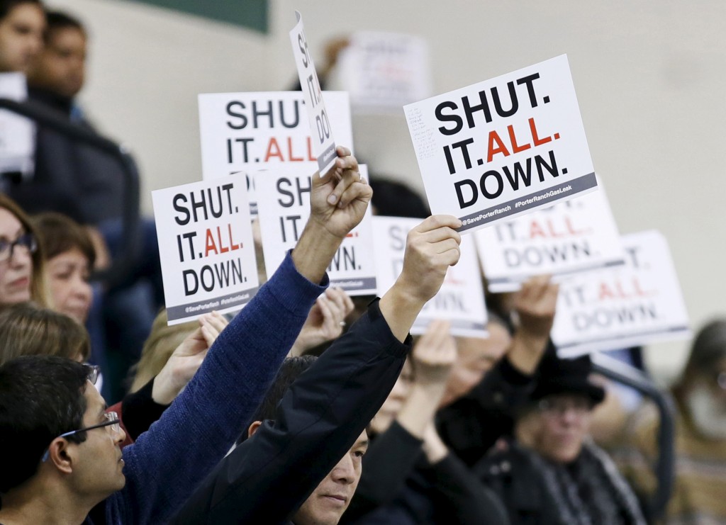 Residents of the Porter Ranch area of Los Angeles hold up signs related to a gas leak in their community during the meeting of the California Air Quality Management District in Granada Hills, California January 9, 2016. Photo by Danny Moloshok/REUTERS