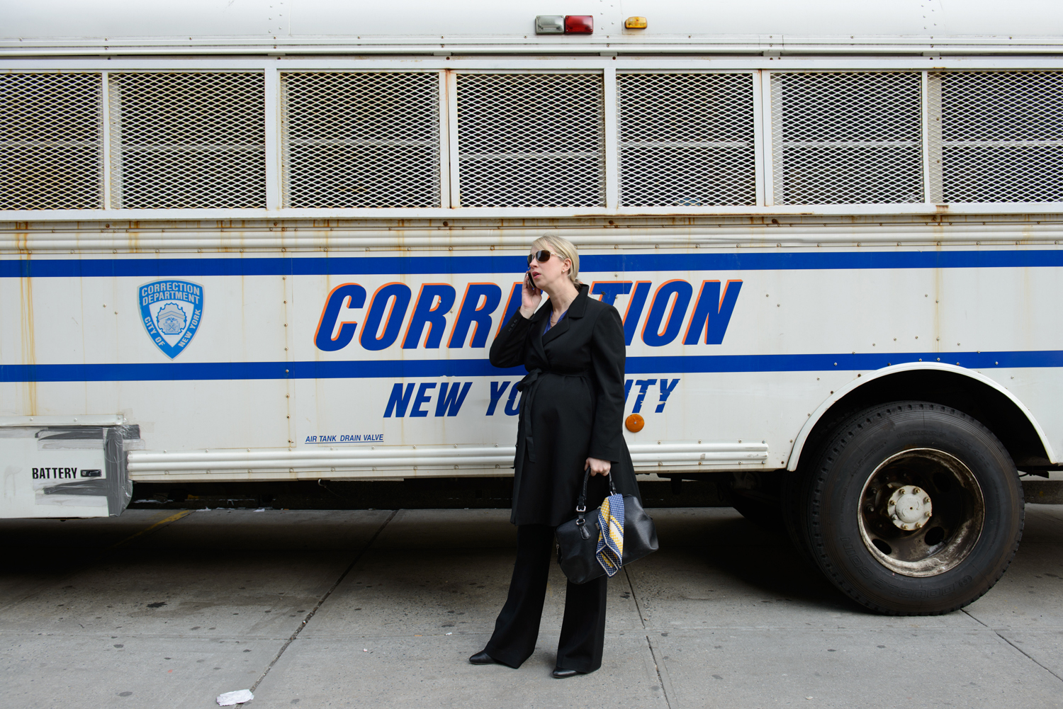 Pregnant Assistant District Attorney Lucy Lang talks on the phone outside of her office.