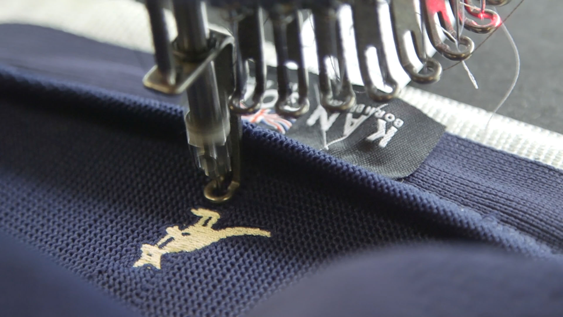 The embroidery of the Kangol Ventair 504 cap after it has been knitted, shaped, and sewn. Photo By Connie Kargbo/PBS NewsHour