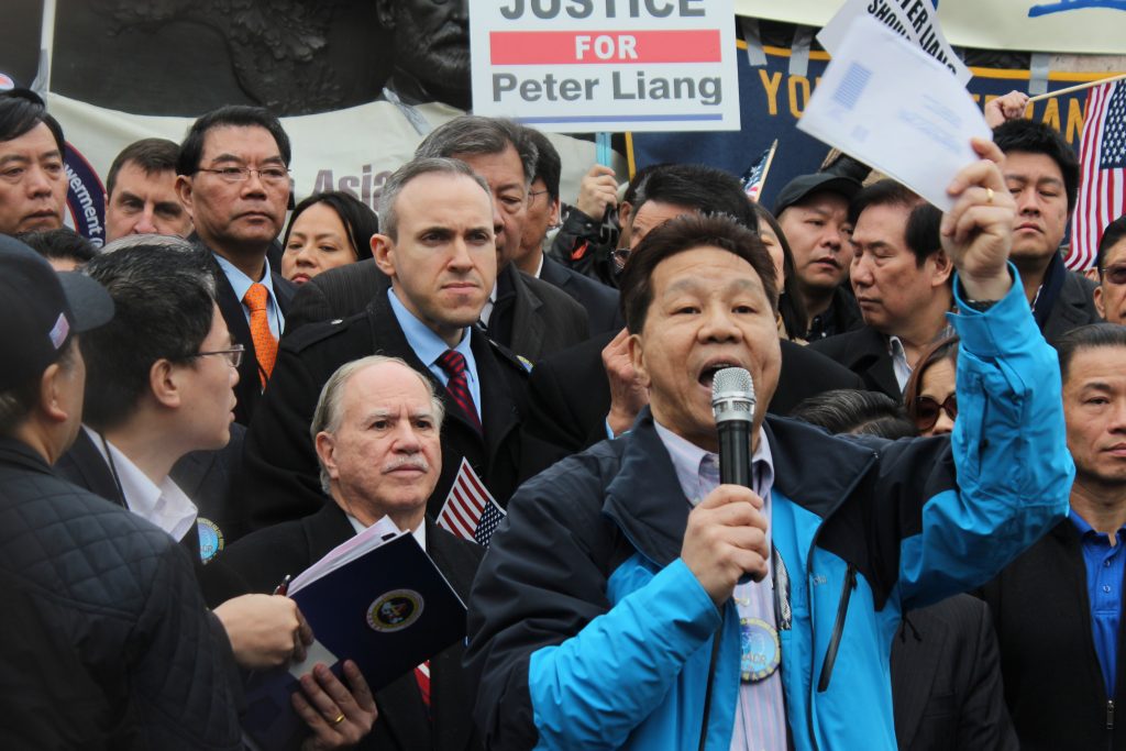 Phil Gim, a community activist, spoke at the protest over conviction of former NYPD officer Peter Liang in New York, urging people to register to vote.