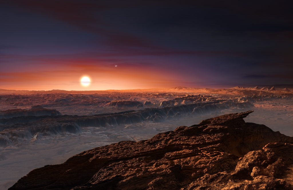 This artist’s impression shows a view of the surface of the planet Proxima b orbiting the red dwarf star Proxima Centauri, the closest star to the Solar System. The double star Alpha Centauri AB also appears in the image to the upper-right of Proxima itself. Proxima b is a little more massive than the Earth and orbits in the habitable zone around Proxima Centauri, where the temperature is suitable for liquid water to exist on its surface. Photo by ESO./L. Calçada/Nick Risinger