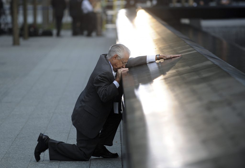 Robert Peraza, who lost his son Robert David Peraza, pauses at his son's name at the North Pool of the 9/11 Memorial during tenth anniversary ceremonies at the site of the World Trade Center in New York. Photo by Justin Lane/Reuters