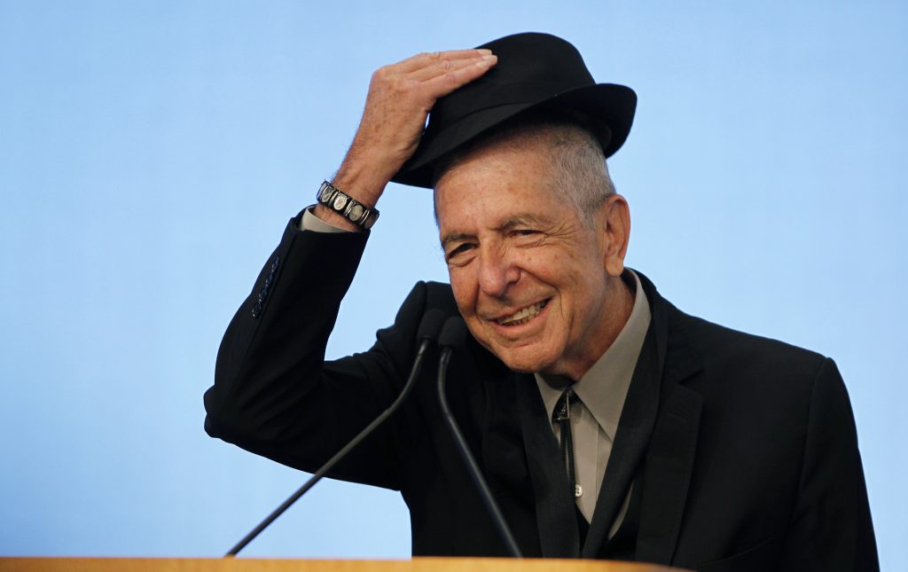 Musician Leonard Cohen tips his hat to the audience as he accepts the 2012 Awards for Song Lyrics of Literary Excellence, which was awarded to both he and Chuck Berry at the John F. Kennedy Presidential Library and Museum, in Boston, Massachusetts February 26, 2012 REUTERS/Jessica Rinaldi (UNITED STATES - Tags: ENTERTAINMENT) - RTR2YHQ8