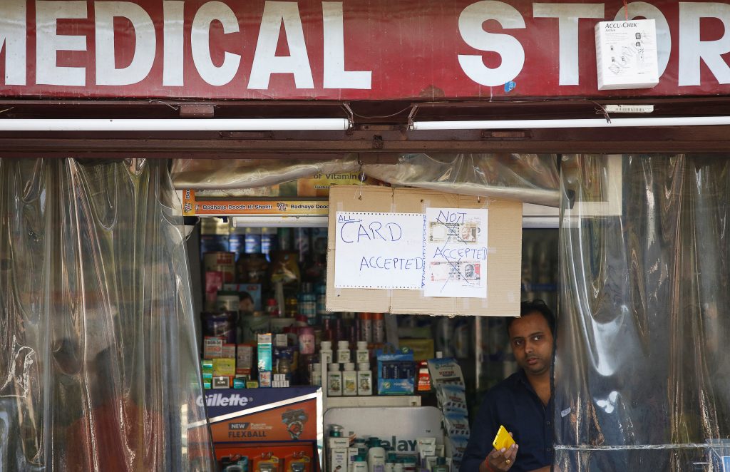 A notice is displayed at a medical store stating the refusal to accept old 500 and 1000 Indian rupee banknotes in Lucknow, India. Photo by Pawan Kumar/Reuters