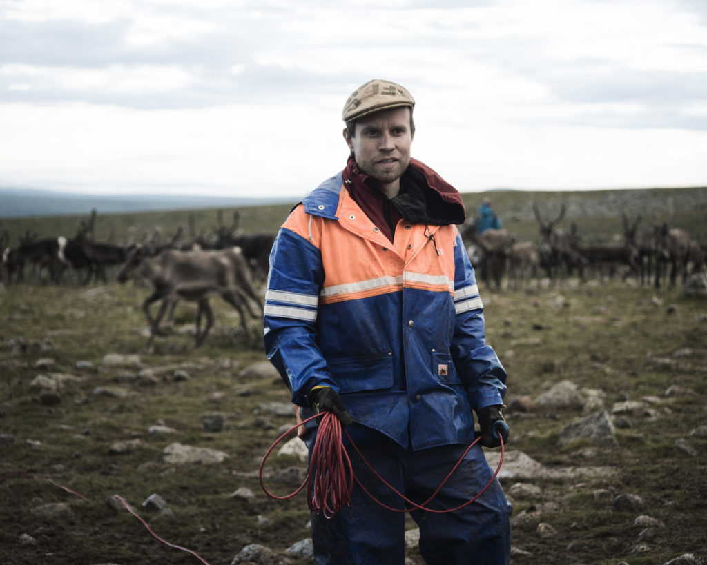 Simon Issát Marainen herds reindeer with his family outside of Nedre Soppero, Sweden. Photo by Camilla Andersen