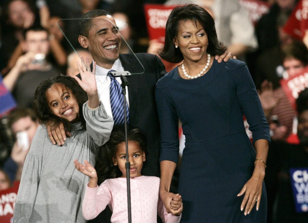 Democratic presidential candidate U.S. Senator Barack Obama (D-IL) is cheered by supporters after he won the Democratic Iowa caucuses in Des Moines, Iowa January 3, 2008. Obama's wife Michelle (R) and daughters Malia (L) and Sasha are seen with him. REUTERS/Keith Bedford (UNITED STATES) - RTX57AQ