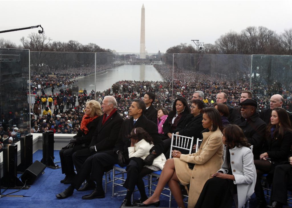 U.S. President-elect Barack Obama (C) puts his arm around his daughter Sasha as they sit onstage with his wife Michelle (2nd R), Malia Obama (far R), Vice President-elect Joe Biden (2nd L) and his wife Jill during the 'We Are One': Inaugural Celebration at the Lincoln Memorial in Washington January 18, 2009. REUTERS/Jim Young (UNITED STATES) - RTR23K7H
