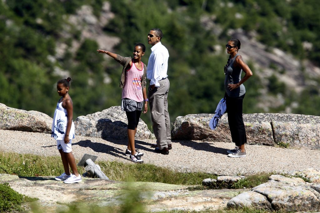 U.S. President Barack Obama (2nd R) and his wife Michelle (R) walk along a trail with their daughters Sasha (L) and Malia on Cadillac Mountain in Bar Harbor, Maine, July 16, 2010. The First Family is on vacation for the weekend. REUTERS/Jim Young (UNITED STATES - Tags: POLITICS TRAVEL) - RTR2GH4V