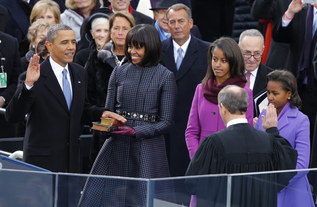 U.S. Supreme Court Chief Justice John Roberts (2nd from R) administers the oath of office to U.S. President Barack Obama (L) as first lady Michelle Obama (C) and daughters Malia and Sasha (R) look on during ceremonies on the West front of the U.S Capitol in Washington, January 21, 2013. REUTERS/Jim Bourg (UNITED STATES - Tags: POLITICS TPX IMAGES OF THE DAY) - RTR3CR1Z