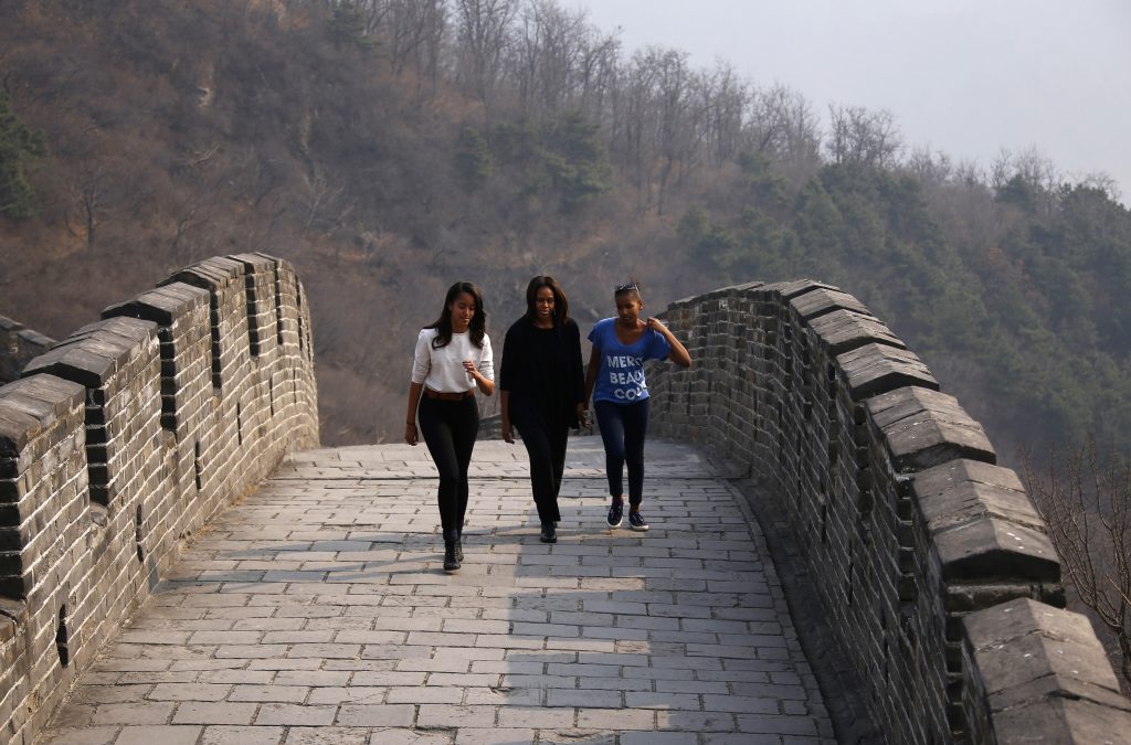 U.S. first lady Michelle Obama (C) walks with her daughters Sasha (R) and Malia as they visit the Mutianyu section of the Great Wall of China, in Beijing March 23, 2014. REUTERS/Petar Kujundzic (CHINA - Tags: POLITICS TRAVEL) - RTR3I778