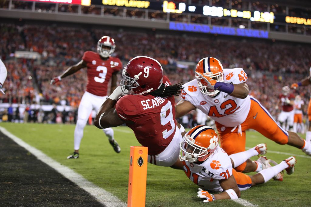 Alabama Crimson Tide running back Bo Scarbrough (9) scores on a 25 yard touchdown past Clemson Tigers defensive back Ryan Carter (31) and defensive lineman Christian Wilkins (42) in the 2017 College Football Playoff National Championship Game at Raymond James Stadium. Photo by Matthew Emmons-USA TODAY Sports