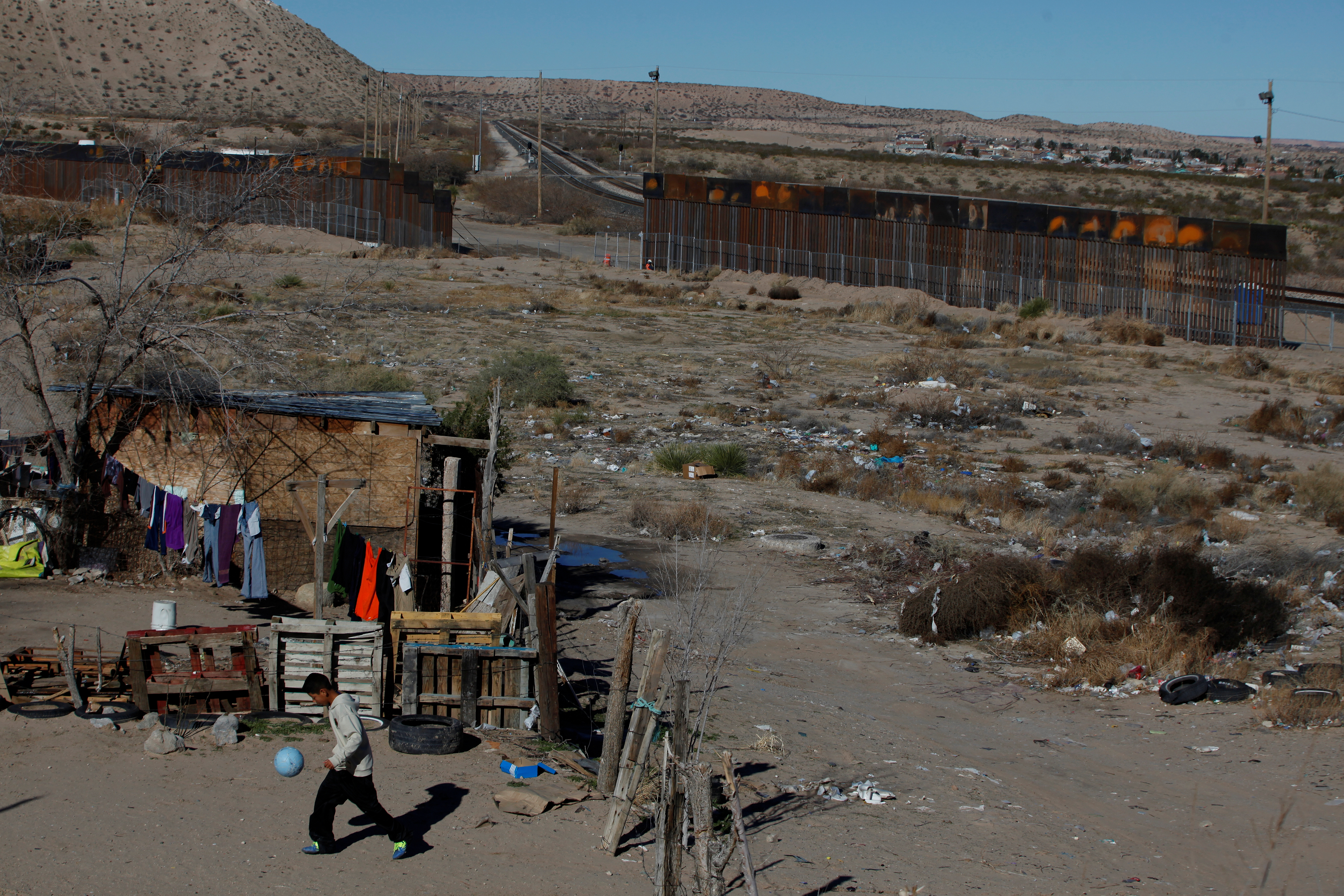 A child plays with a ball at his house along the U.S.-Mexico border fence on Jan. 25. Photo by Jose Luis Gonzalez/Reuters