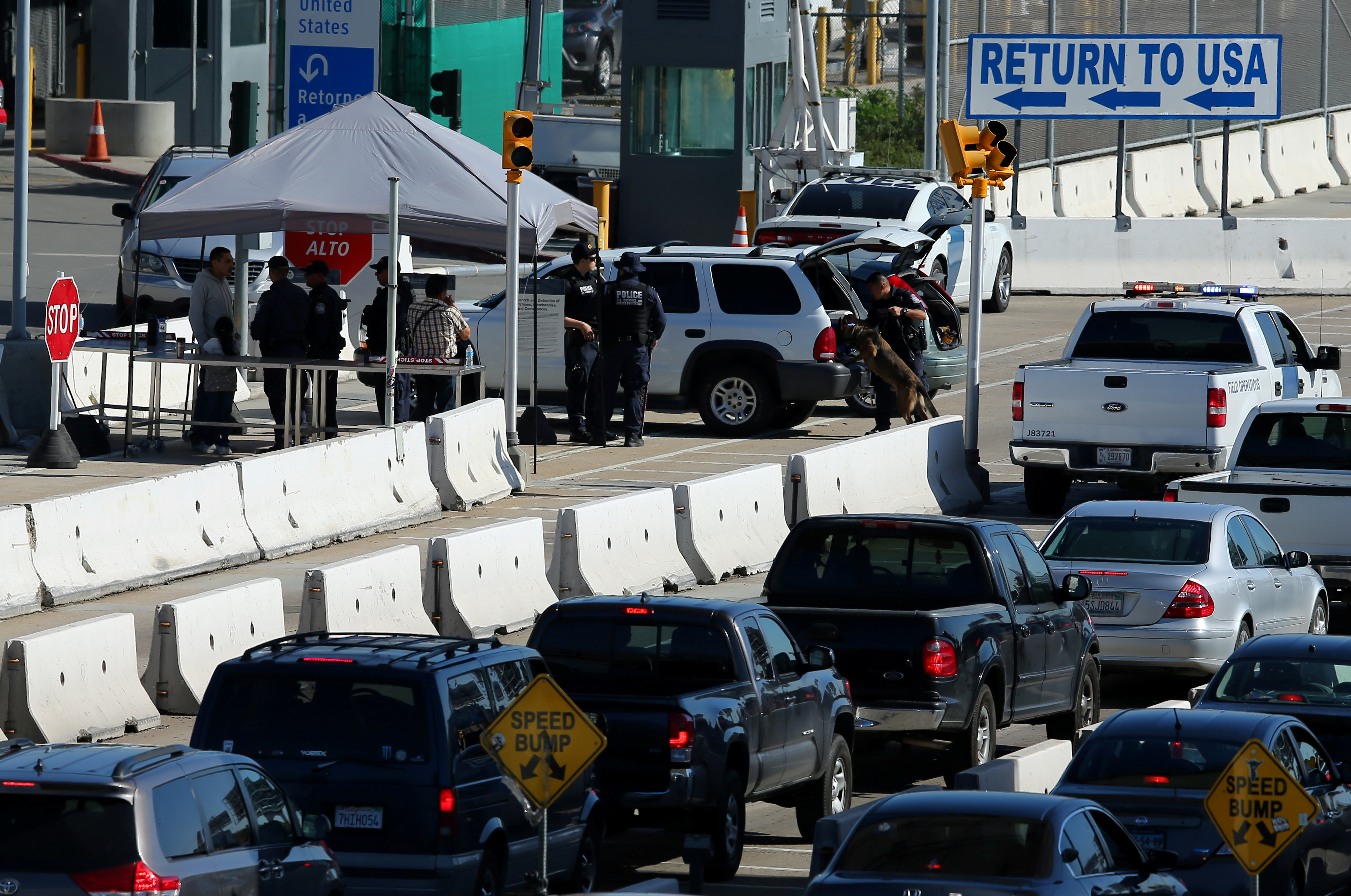 U.S. Customs and Border Patrol agents check vehicles in San Ysidro, California, along the Mexico border. Photo by Mike Blake/Reuters