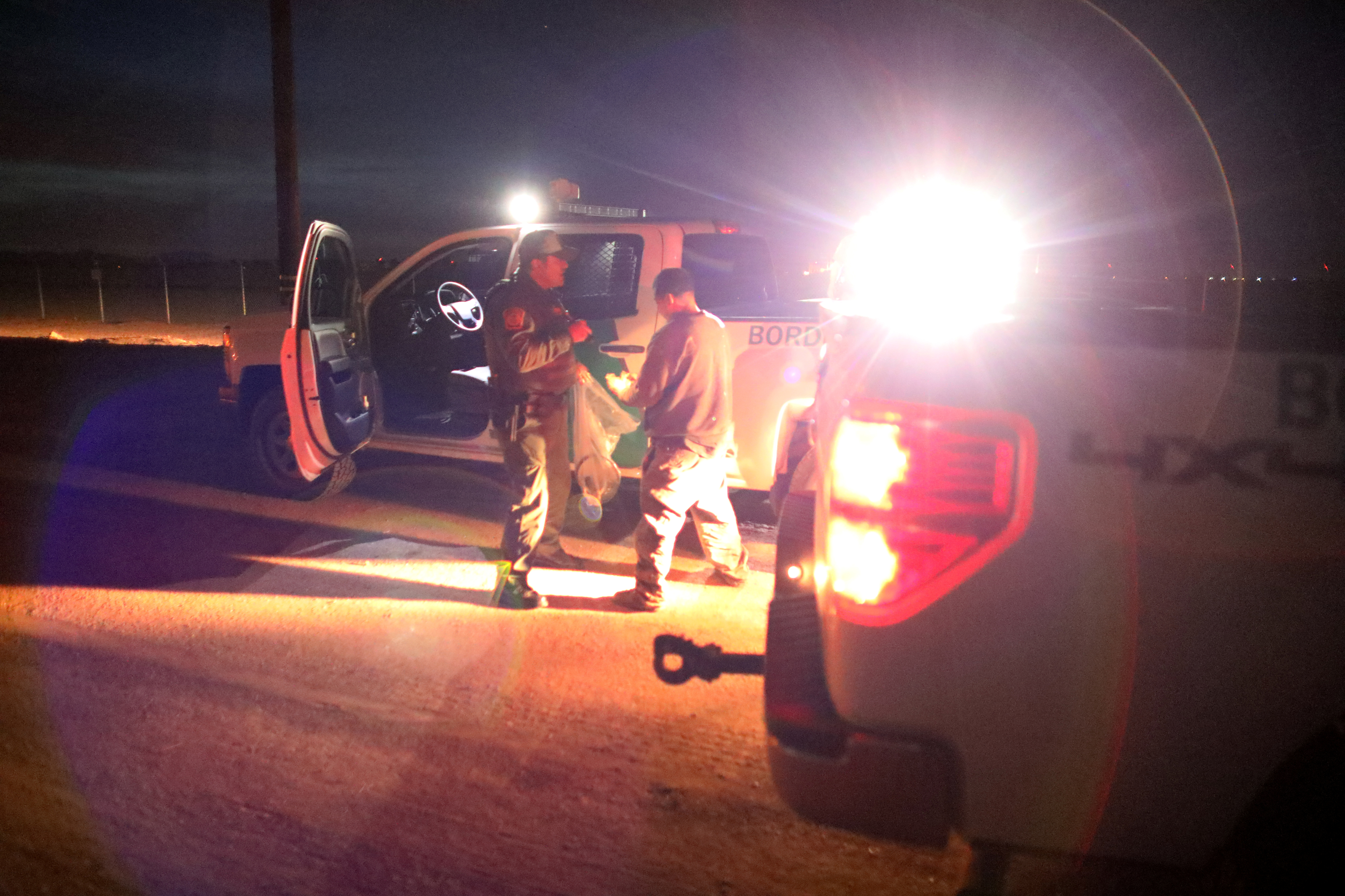 U.S. border patrol agents detain a man after he was spotted crossing illegally into the United States along the Mexican border near Calexico, California on Feb. 8. Photo by Mike Blake/Reuters