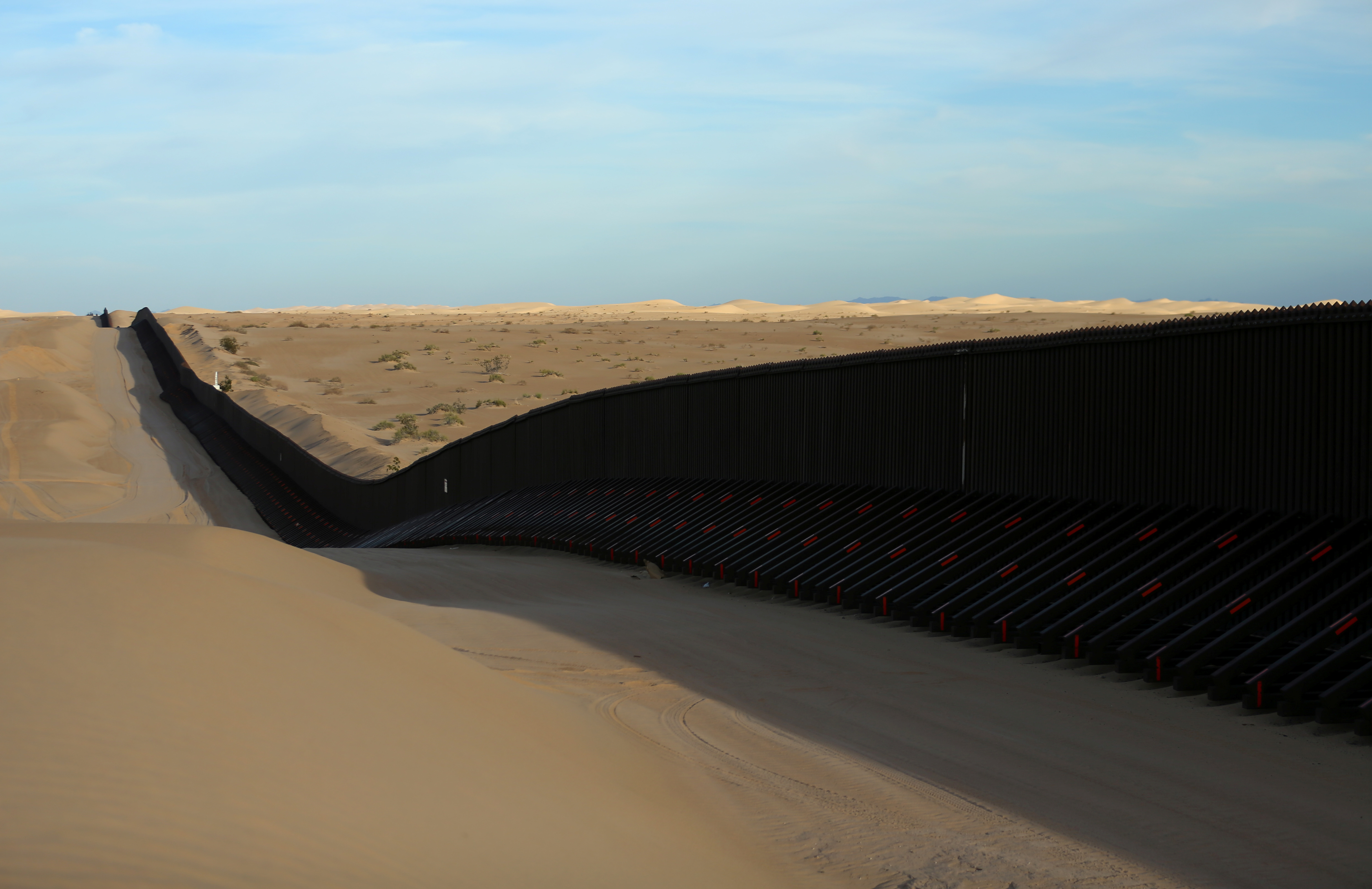 The barrier between Mexico and the U.S. is a series of walls and fences, along with natural barriers of rivers and cliffs. Photo by Mike Blake/Reuters