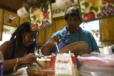 Sharissa Derricott helps her mother Cheryl prepare dinner at her parents’ home in Lawton Oklahoma. Derricott says she took Lupron from age 5 to 12 to shut down early puberty. At 30, she’s among the first patients who took the drug – even before it was approved for pediatric use. (Nick Oxford/for KHN)