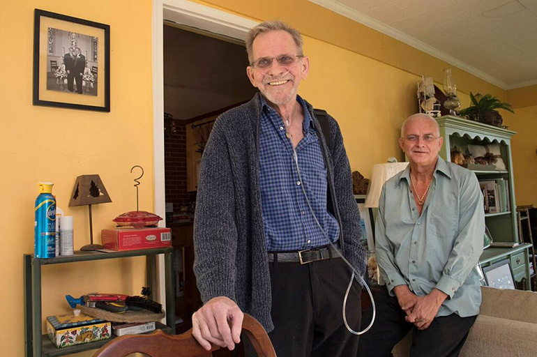 Bruce Mead-e, left, and his husband, Chuck Mead-e, 60, had a meeting with a pastoral care provider who emphasized the bright side of things, Bruce says. It helped me feel hopeful. (Eileen Blass for Kaiser Health News)