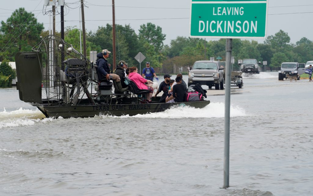 People are rescued by airboat as they evacuate from flood waters from Hurricane Harvey in Dickinson, Texas August 27, 2017. Photo by Rick Wilking/REUTERS