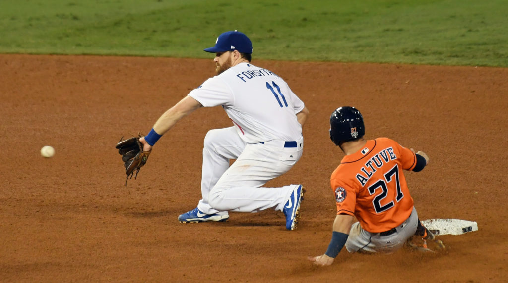 Houston Astros second baseman Jose Altuve (27) steals second against Los Angeles Dodgers second baseman Logan Forsythe (11) in the seventh inning in game seven of the 2017 World Series at Dodger Stadium. Mandatory Credit: Richard Mackson-USA TODAY Sports