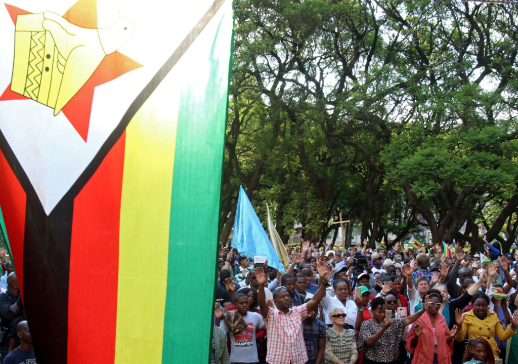Residents attend a prayer meeting called to celebrate after Zimbabwean President Robert Mugabe was dismissed as party leader of the ruling ZANU-PF's central committee in Harare