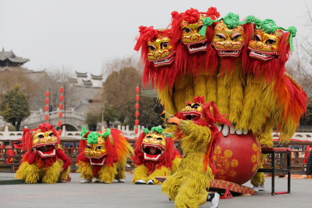 Folk artists perform a lion dance ahead of the Chinese Lunar New Year, or Spring festival, at Taierzhuang Ancient Town scenic area in Zaozhuang, Shandong province, China. REUTERS/Stringer
