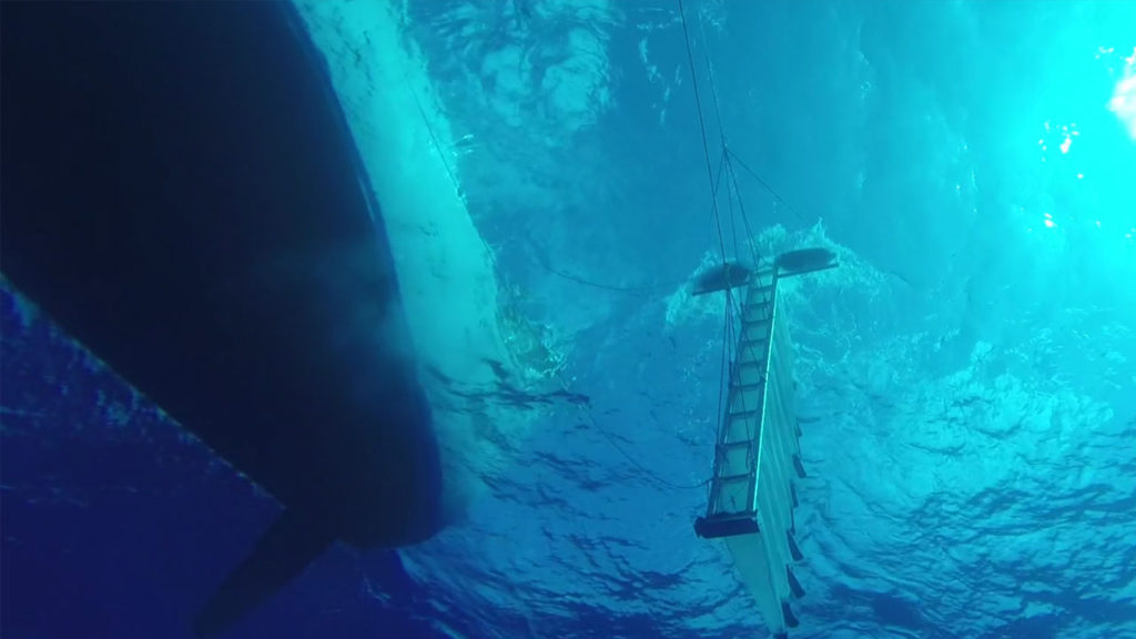 A multilevel trawl, photographed from below, samples the surface waters of the ocean. Photo by The Ocean Cleanup