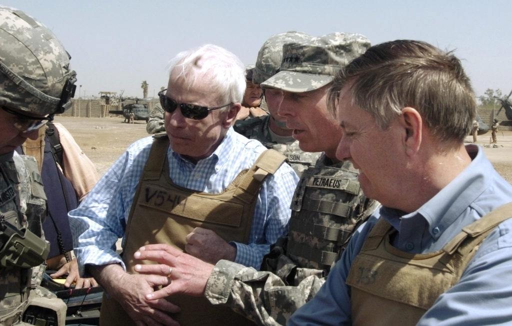 U.S. Senators John McCain (R-AZ) and Lindsey Graham (R-SC) (R) get a briefing from General David Petraeus (2nd R), U.S. Commander in Iraq, and an unidentified military escort (L) as they visit the Shorga marketplace and interacted with local merchants while walking the streets of Baghdad April 1, 2007. Photo taken April 1, 2007. REUTERS/Sergeant Matthew Roe/10th Public Affairs Operations Center/Handout (IRAQ). EDITORIAL USE ONLY. NOT FOR SALE FOR MARKETING OR ADVERTISING CAMPAIGNS. - GM1DUYLXNSAA