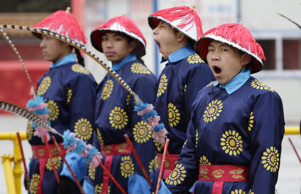 Actors yawn as they take part in a rehearsal for the upcoming temple fair, adapted from an ancient Qing Dynasty ceremony where emperors prayed for good harvest and fortune, at Ditan Park (the Temple of Earth), in Beijing January 20, 2012. Photo by REUTERS/Jason Lee