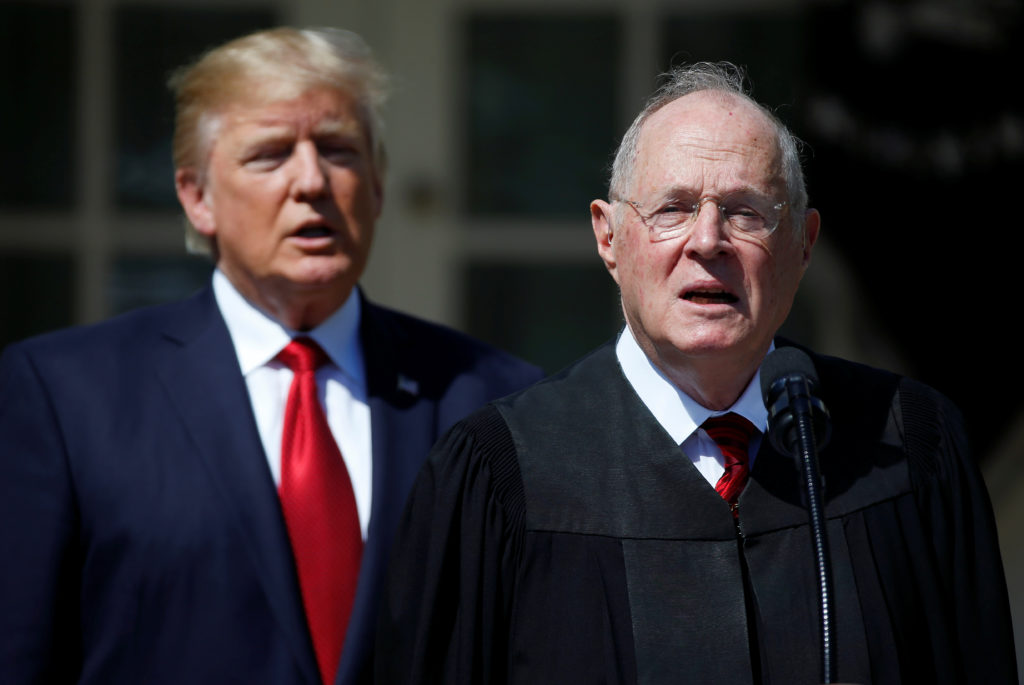 U.S. President Donald Trump listens as Justice Anthony Kennedy speaks before swearing in Judge Neil Gorsuch as an Associate Supreme Court Justice in the Rose Garden of the White House in Washington, U.S., April 10, 2017. REUTERS/Joshua Roberts - RC15570B9710