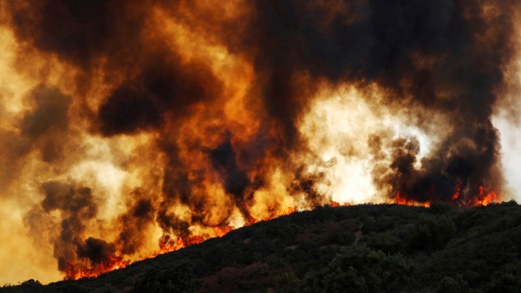 Wind-driven flames roll over a hill towards homes during the River Fire (Mendocino Complex) near Lakeport, California, U.S. August 2, 2018. Photo by Fred Greaves/Reuters