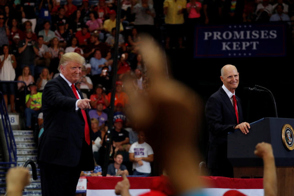 Florida Governor Rick Scott (R) speaks at a campaign rally with U.S. President Donald Trump in Estero, Florida, U.S., October 31, 2018. Photo by Carlos Barria/Reuters