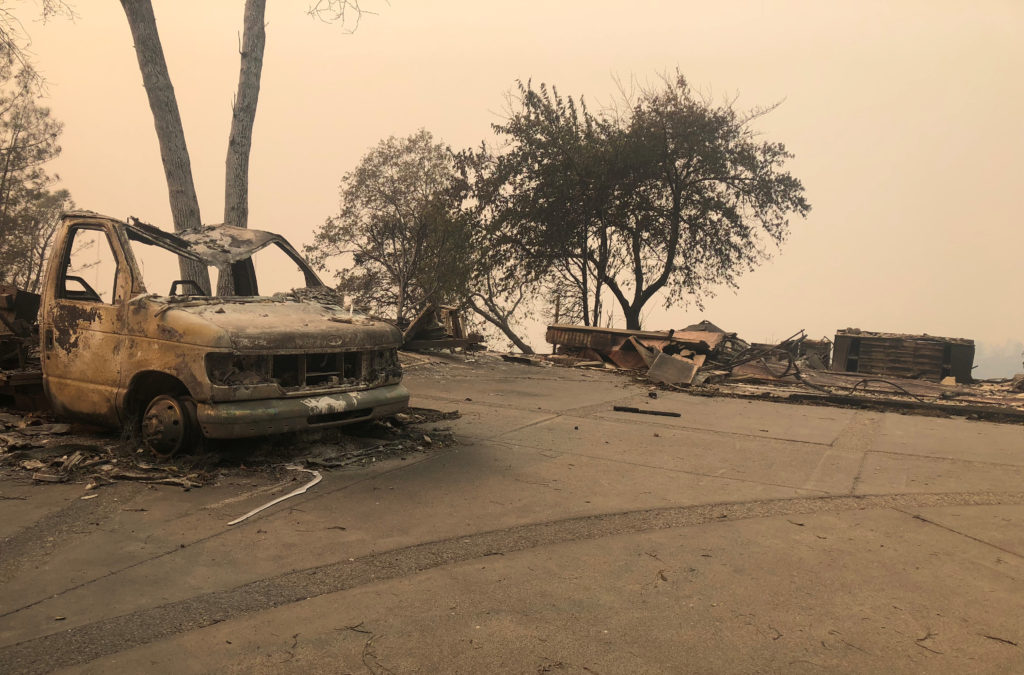 The wreckage of a vehicle is seen along the road in the aftermath of wildfires in Paradise, California, U.S., November 12, 2018. REUTERS/Sharon Bernstein 