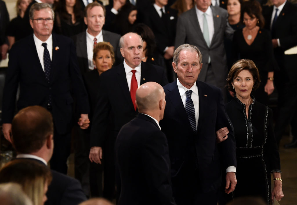 Former US President George W Bush (2R) and former first lady Laura Bush walk past the casket (unseen) bearing the remains of former US President George H.W. Bush at the US Capitol during the State Funeral in Washington, DC, December 3, 2018. Brendan Smialowski/Pool via REUTERS - RC186BE04FB0